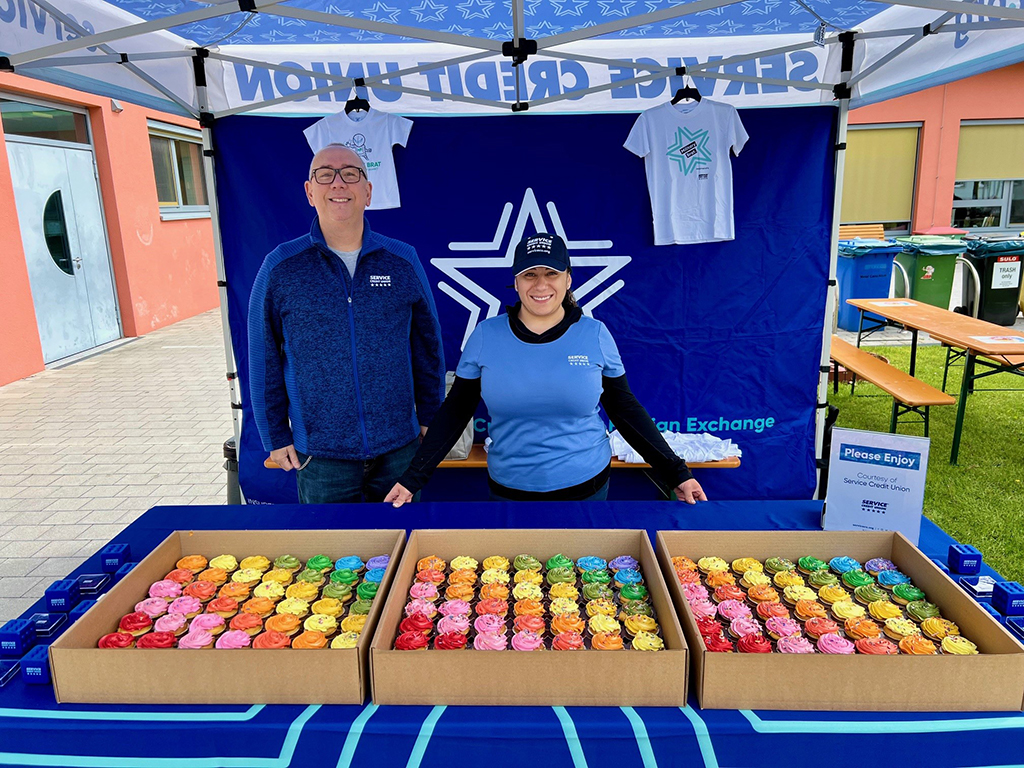bank members showing their display of cupcakes