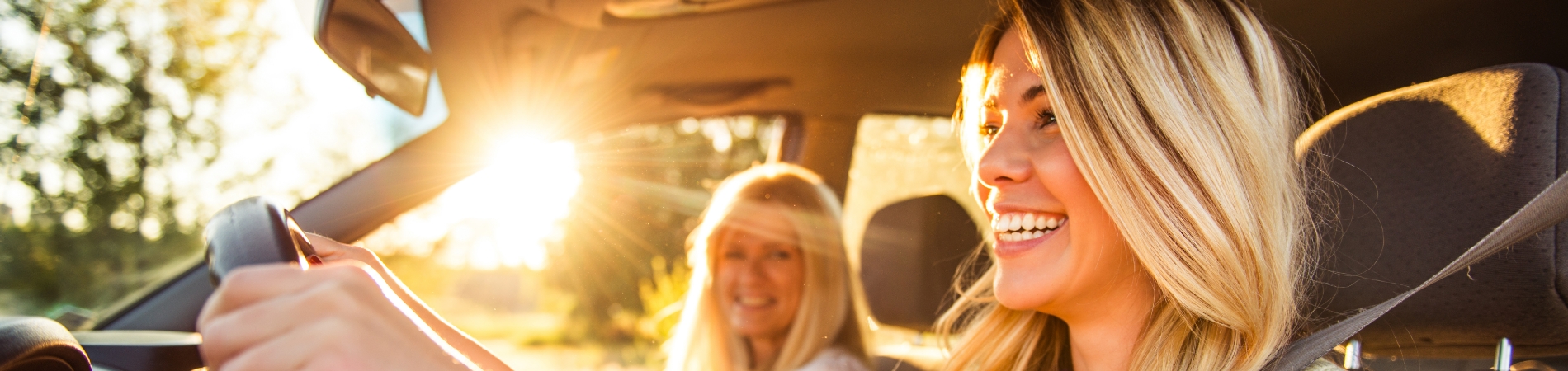two women in a car smiling